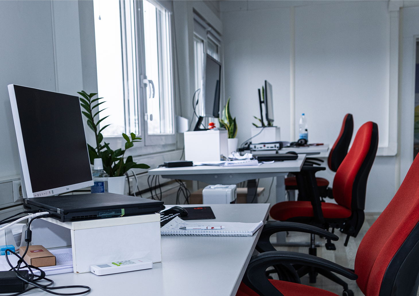 A desk with a computer on it, ready for work.