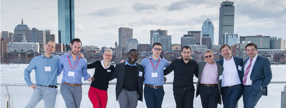 A group of individuals posing in front of a stunning city skyline.