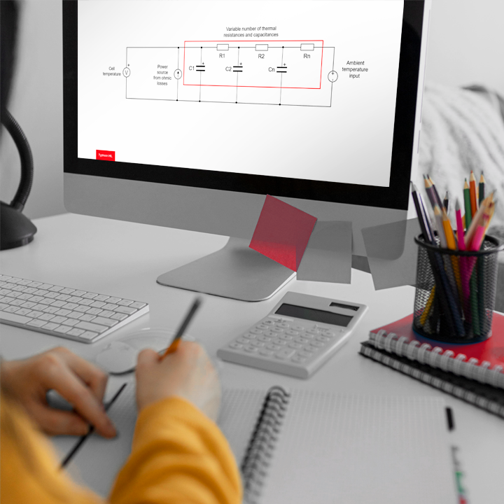 A person focused on a computer screen, working diligently with a diagram displayed.