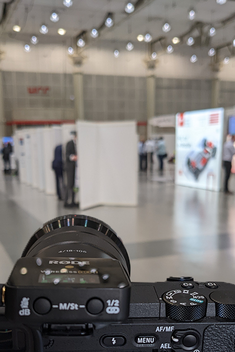 A camera placed in a fair hall, capturing the surroundings and ready to capture moments.