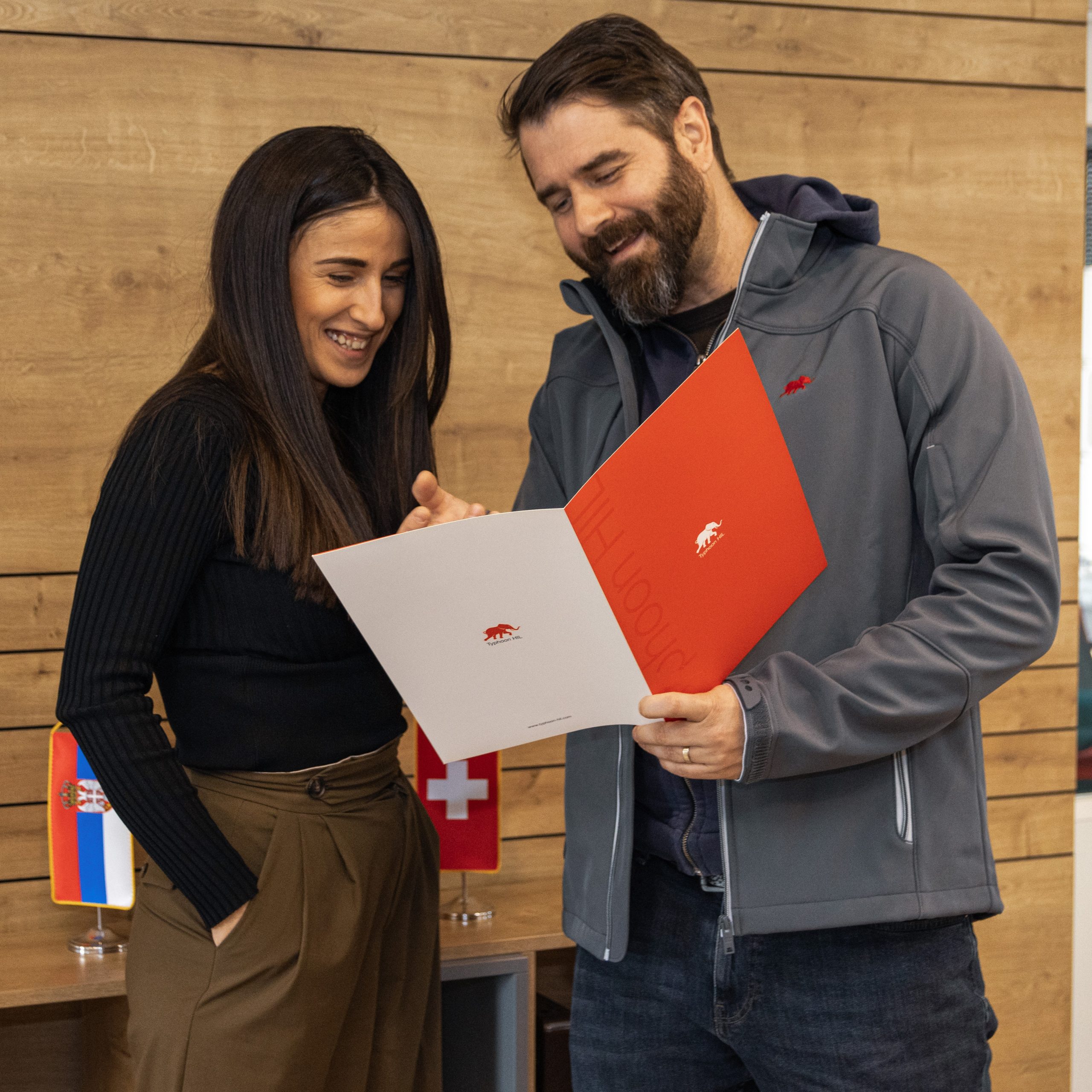 A man and woman attentively examining a folder.