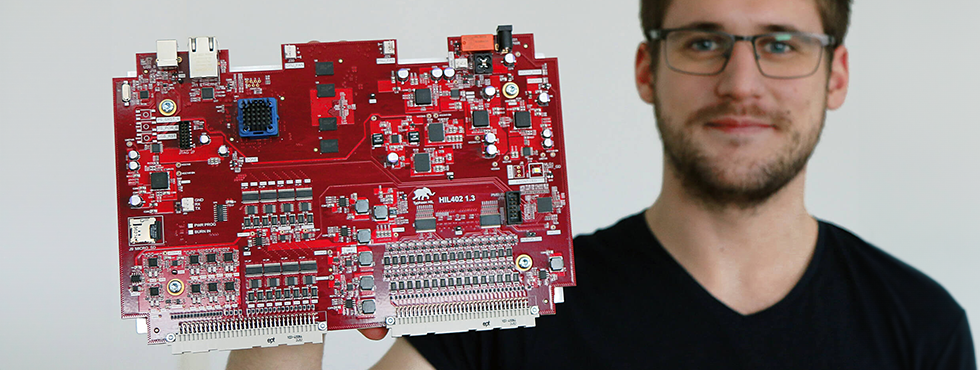 A man showing a red PCB board.